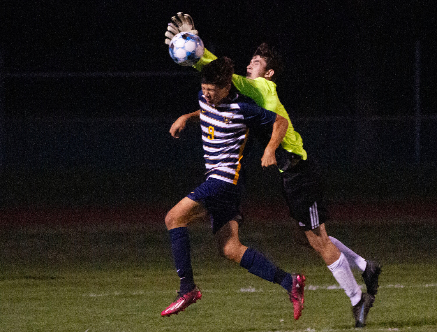 The Eagles’ George Zukhov fights for a direct kick with Huskies’ goal keeper Evan Garies near the Huskies’ goal.