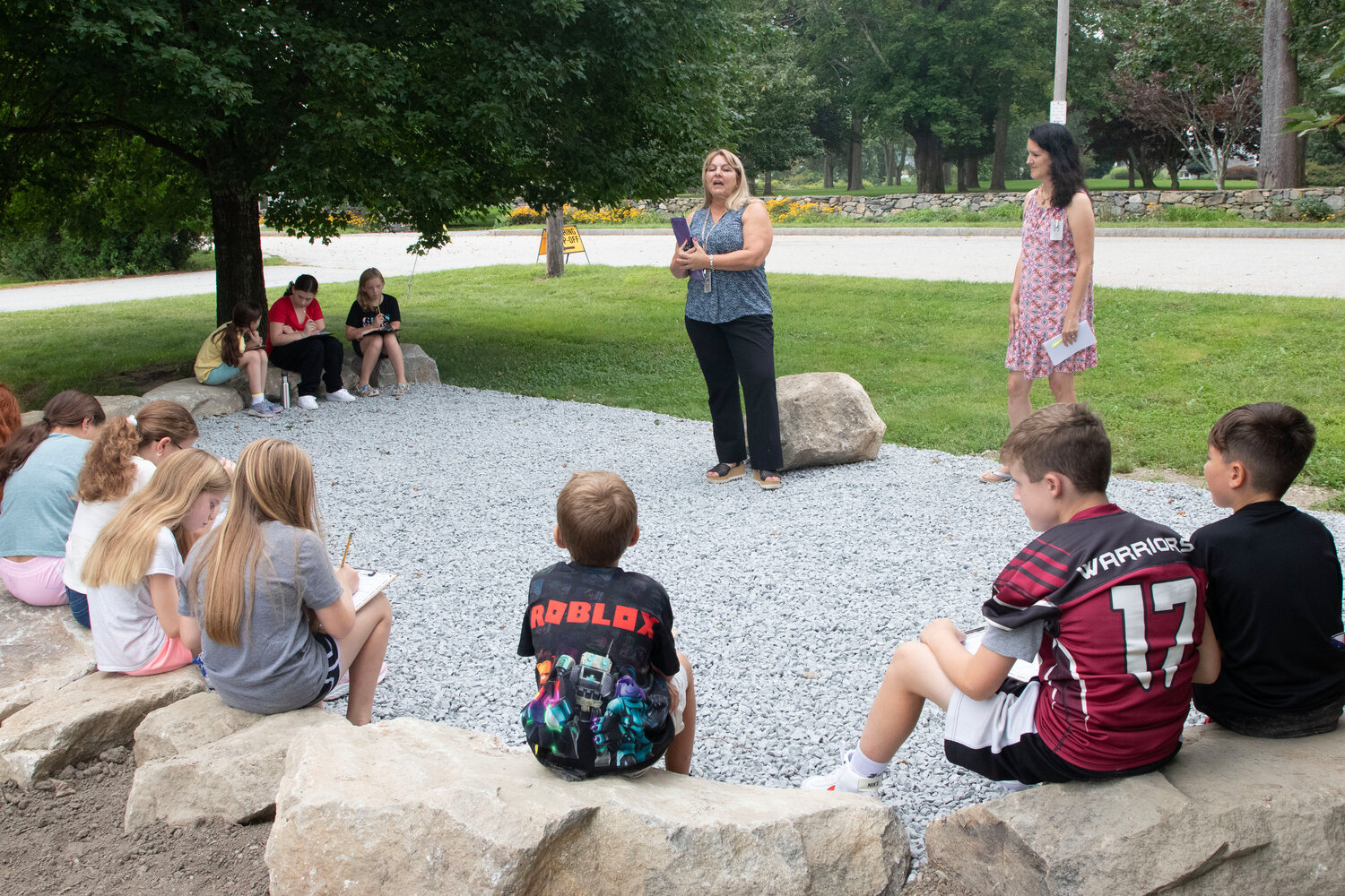 Lynn Palmieri and Hugh Cole psychologist Laurie Hayden instruct students at the new outdoor space.