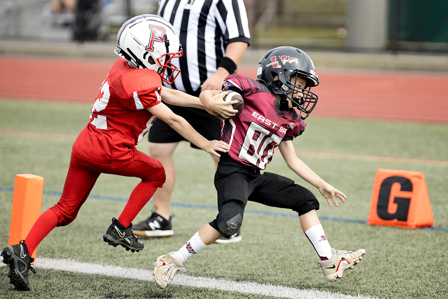 8U's Francis Furtado skids past a Portsmouth defender to score an extra point. 
