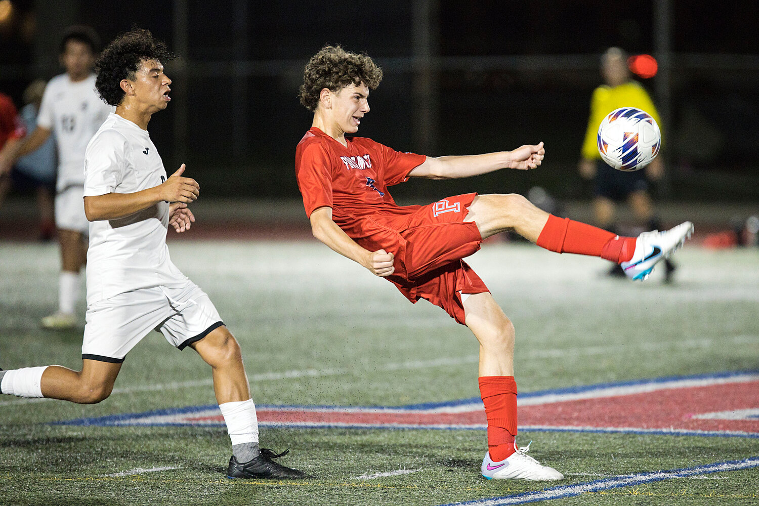 Midfielder Kyle Bielawa sends a pass over his and his opponent’s head.