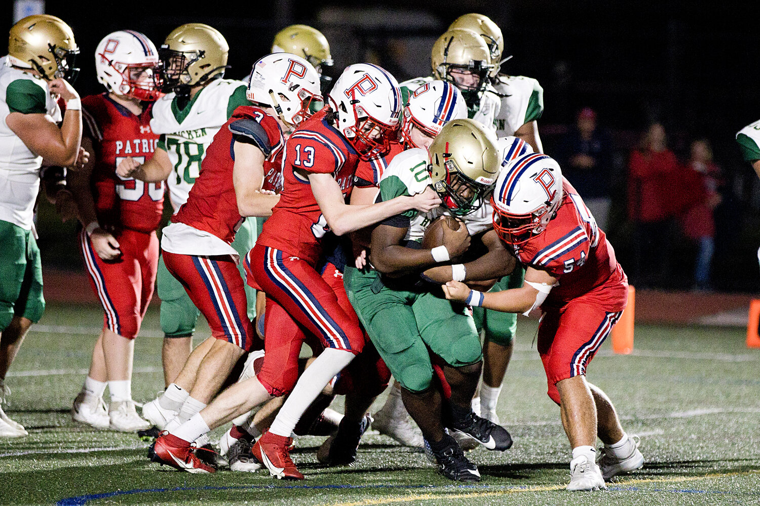 Jack Sanderson (13), Tyler Hurd (middle), and Tristan Conheeny (right), surround a Hendricken ball-carrier.