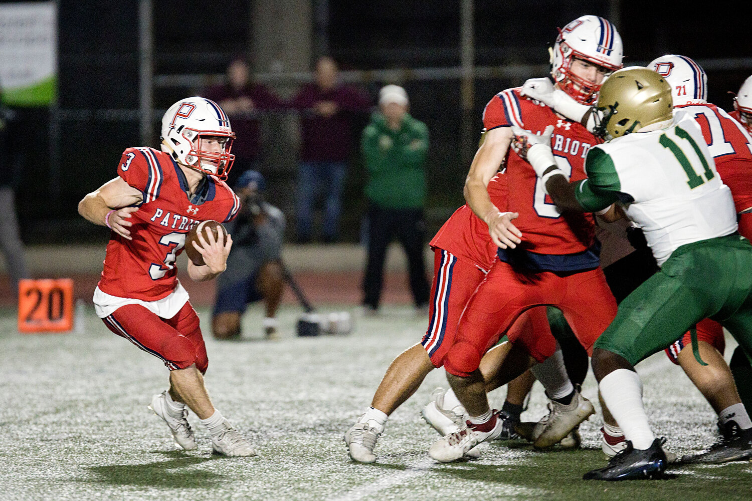 Jack Voute looks for a hole while running the ball for the Patriots.