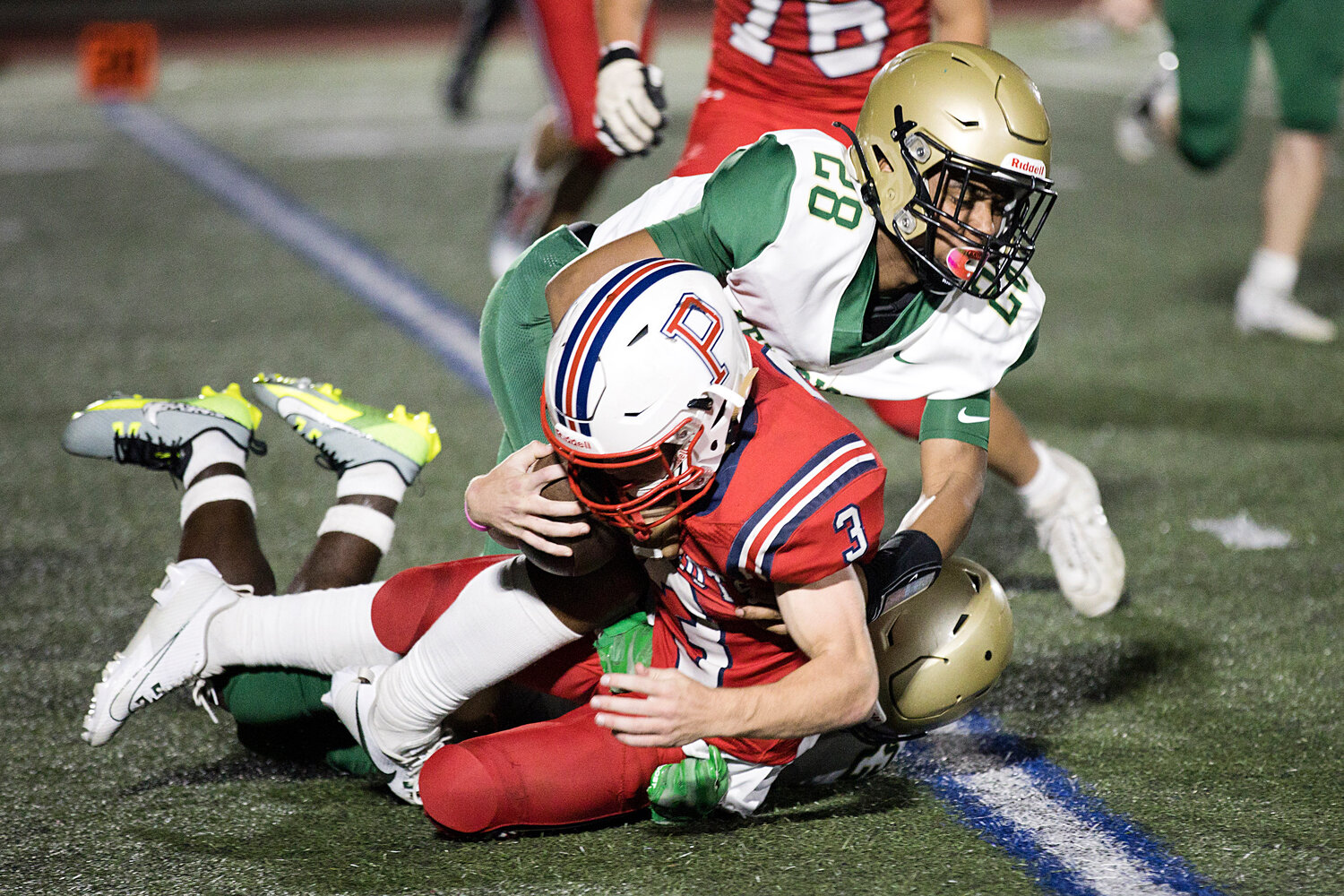 Patriots running back Jack Voute is taken down by a Hendricken defender during last Thursday’s non-league game at home.