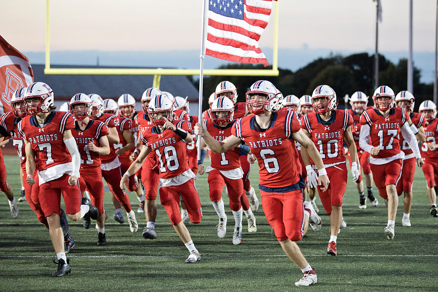 The Portsmouth Patriots varsity football team takes the field before facing Bishop Hendricken in a non-league match at home last Thursday night.