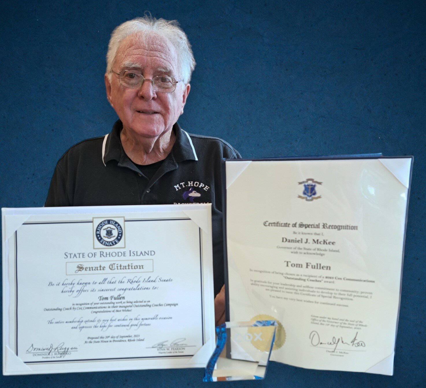 Mt. Hope High School's Tom Fullen poses with his Outstanding Coaches Award citations from the State of Rhode Island.