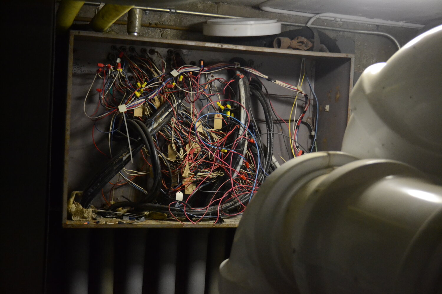 A mess of wires sits exposed in a side room off from the main boiler room. The panel is active, according to school personnel.