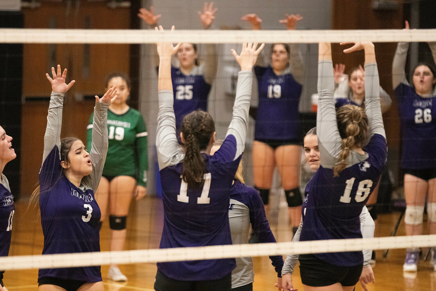 Daniela DeSano (left) and the Huskies celebrate after an ace.