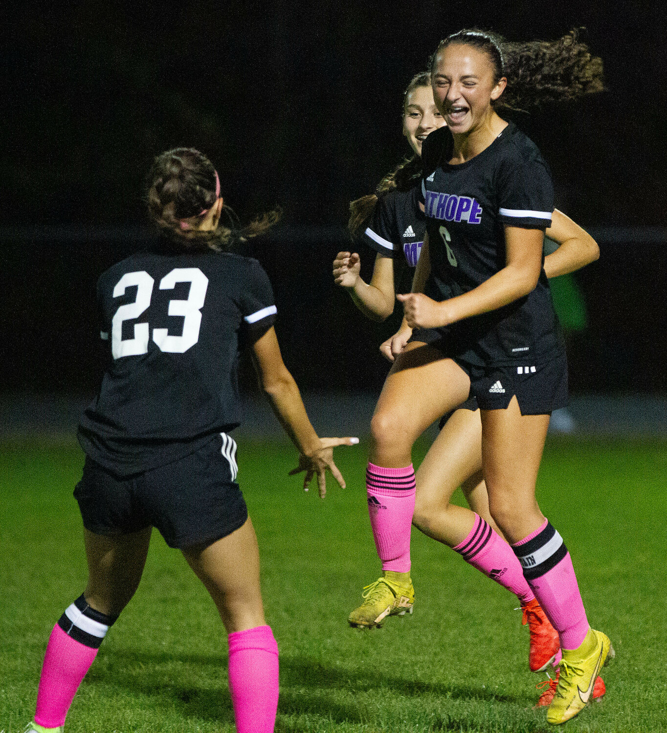 Hannah Rezendes (left) gets ready to catch an elated Caitlyn Terceiro (right) after she scored during the Huskies win over East Greenwich.