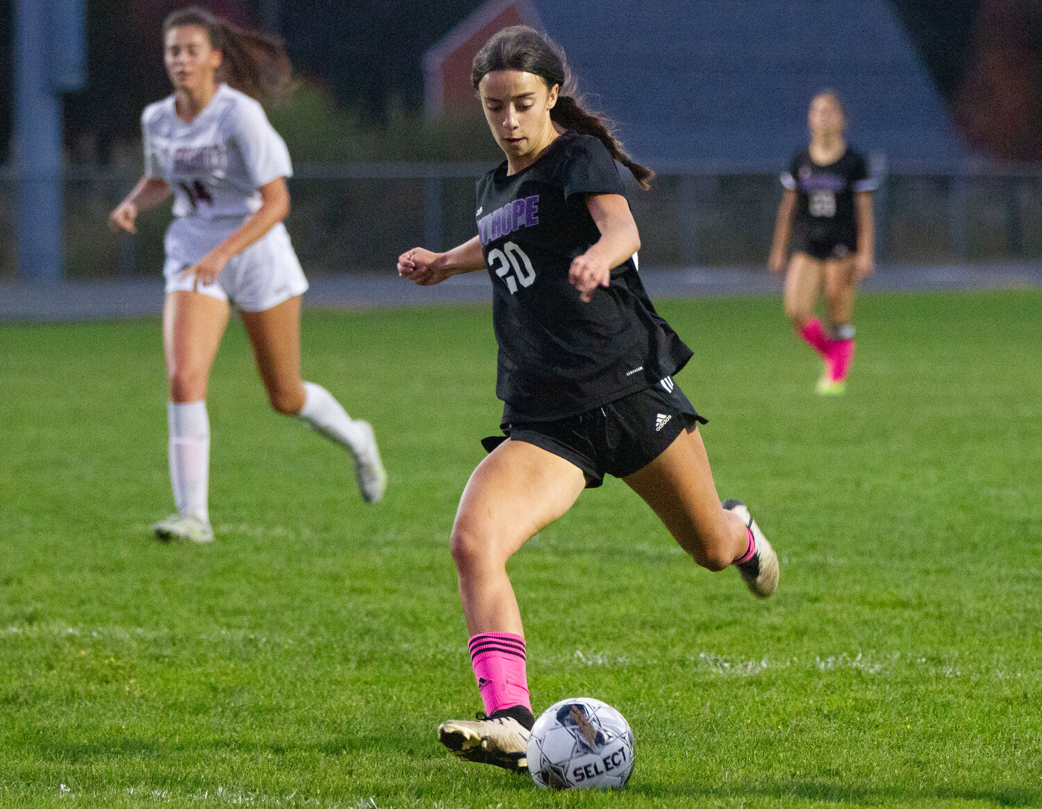 Thea Jackson dribbles through a pair of defenders for a kick on goal in the first half of the Huskies 3-1 win over East Greenwich. She kicked off the scoring in the second half. 