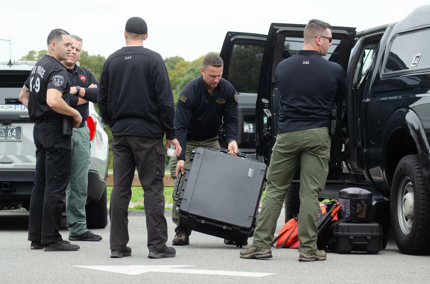 Rhode Island State Police troopers pack up gear following a search for a missing 19-year-old Barrington girl on Friday, Oct. 20.