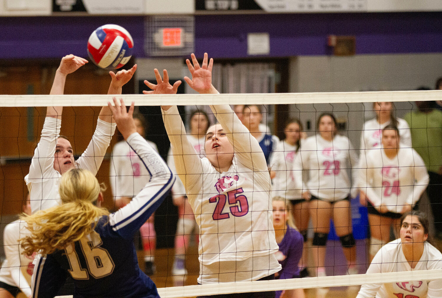 Mia Shaw (left) and Gianna Lunney team up to block a Westerly spike. With Abby Allen look on at right.