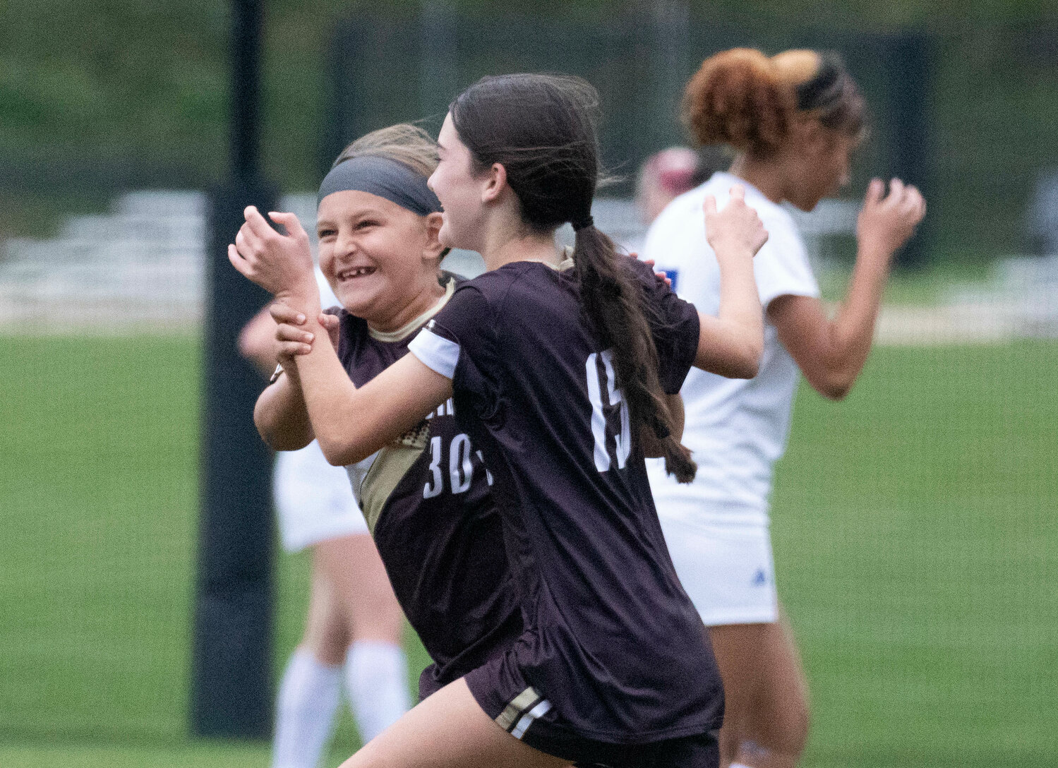 Harper Thibodeau (left) and Sophia Nickelson celebrate after Nickelson scored her second goal of the game.