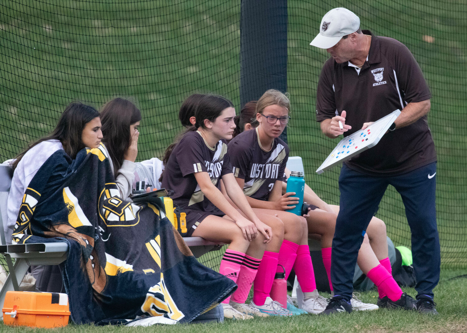 Head coach Gary Muello gives instruction to Sophia Nickelson (left).