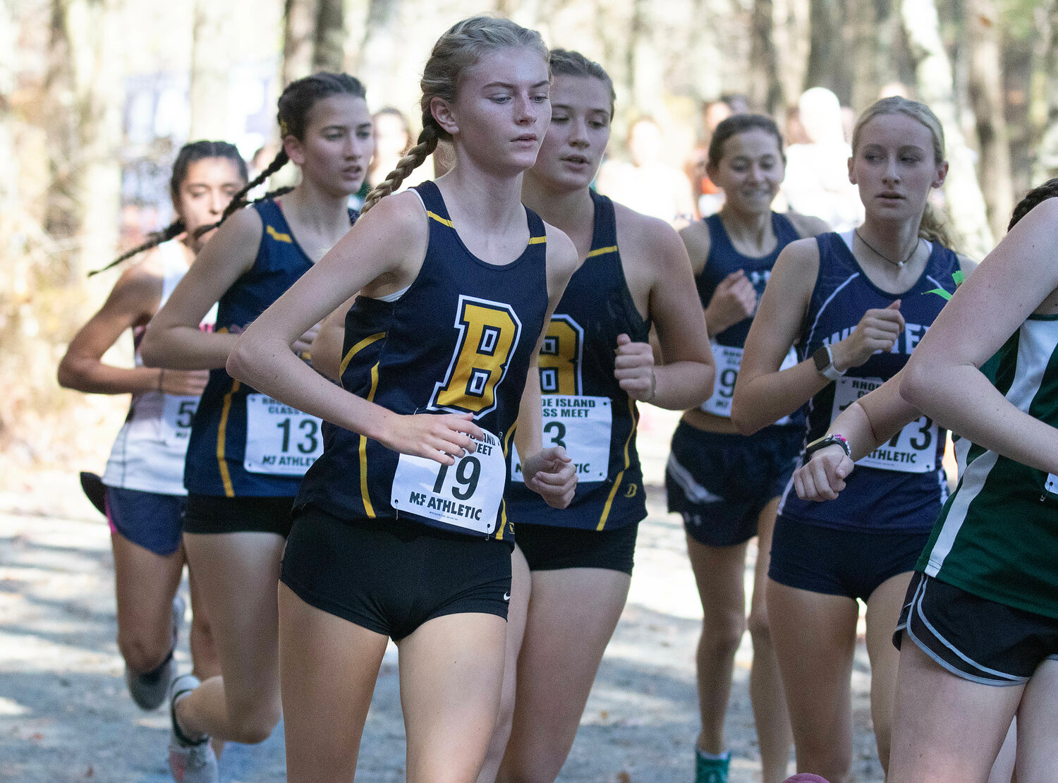 Maeve Kelly (left) leads teammates Sophie Gardos (left) and Jane Bryant (right) along the course at the Class B Championship on Saturday.