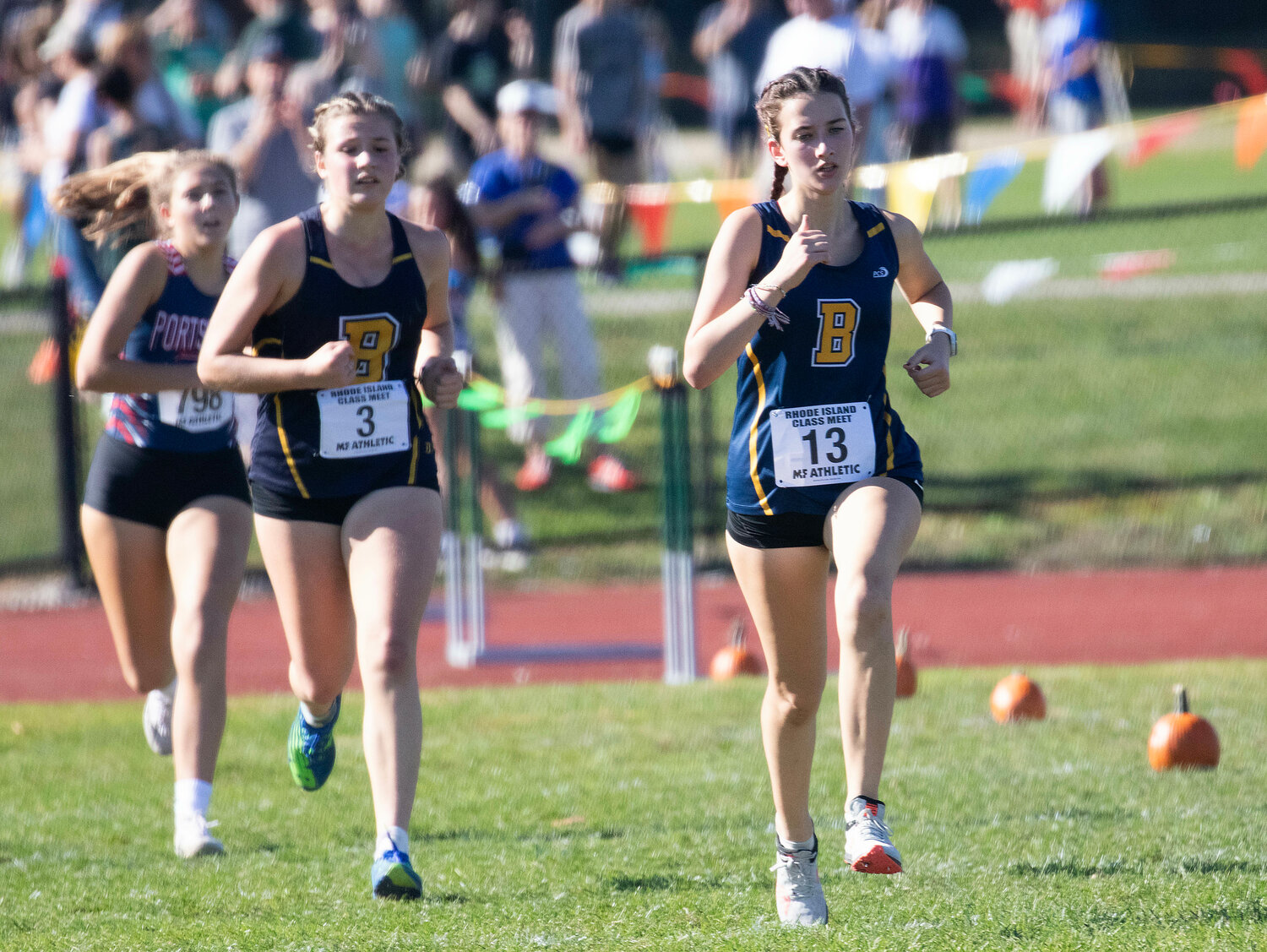 Barrington’s Jane Bryant (left) and Sophie Gardos race toward the finish line in the Class B Championship at Ponaganset High School on Saturday.