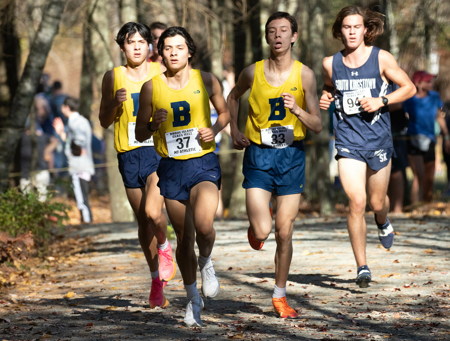 Barrington High School’s Michael Chun, Daniel Chun and Marius Bonard (from left to right) run along the course at the Class B Championship on Saturday.