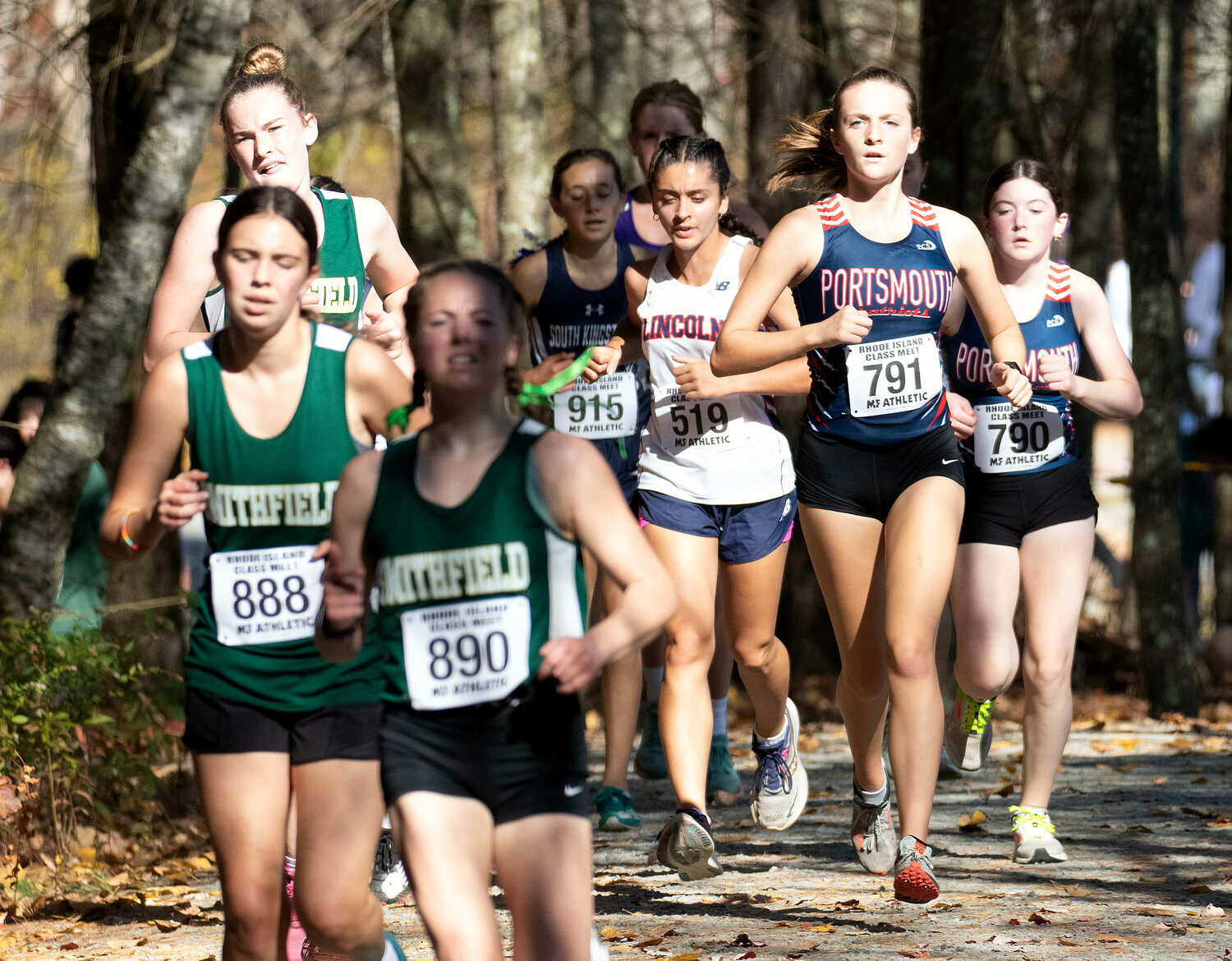 Addie Dalton and Marin Cooney (far right), navigate the wooded part of the course.