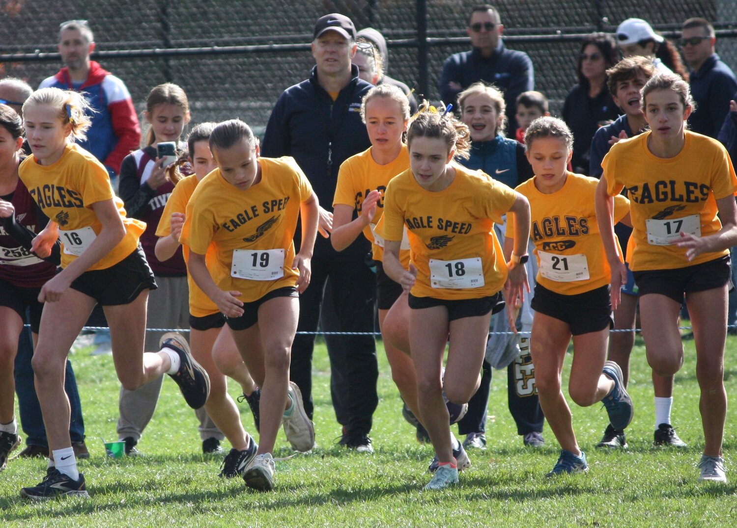 Barrington Middle School runners (from left to right) Kendall Blaney, Molly Reagan, Carley Gill, Abby Glass, Gracie Gaines, Annabelle Meech, and Charlotte Farrell break from the starting line during the Oct. 22 state championship race at Ponaganset High School.