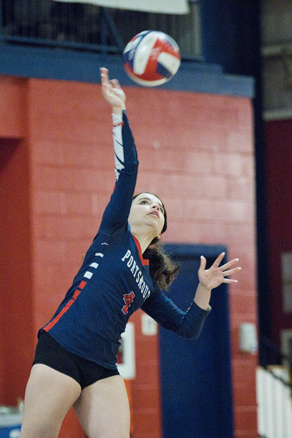 The Patriots’ Maci Krzych serves the ball to the Rams.