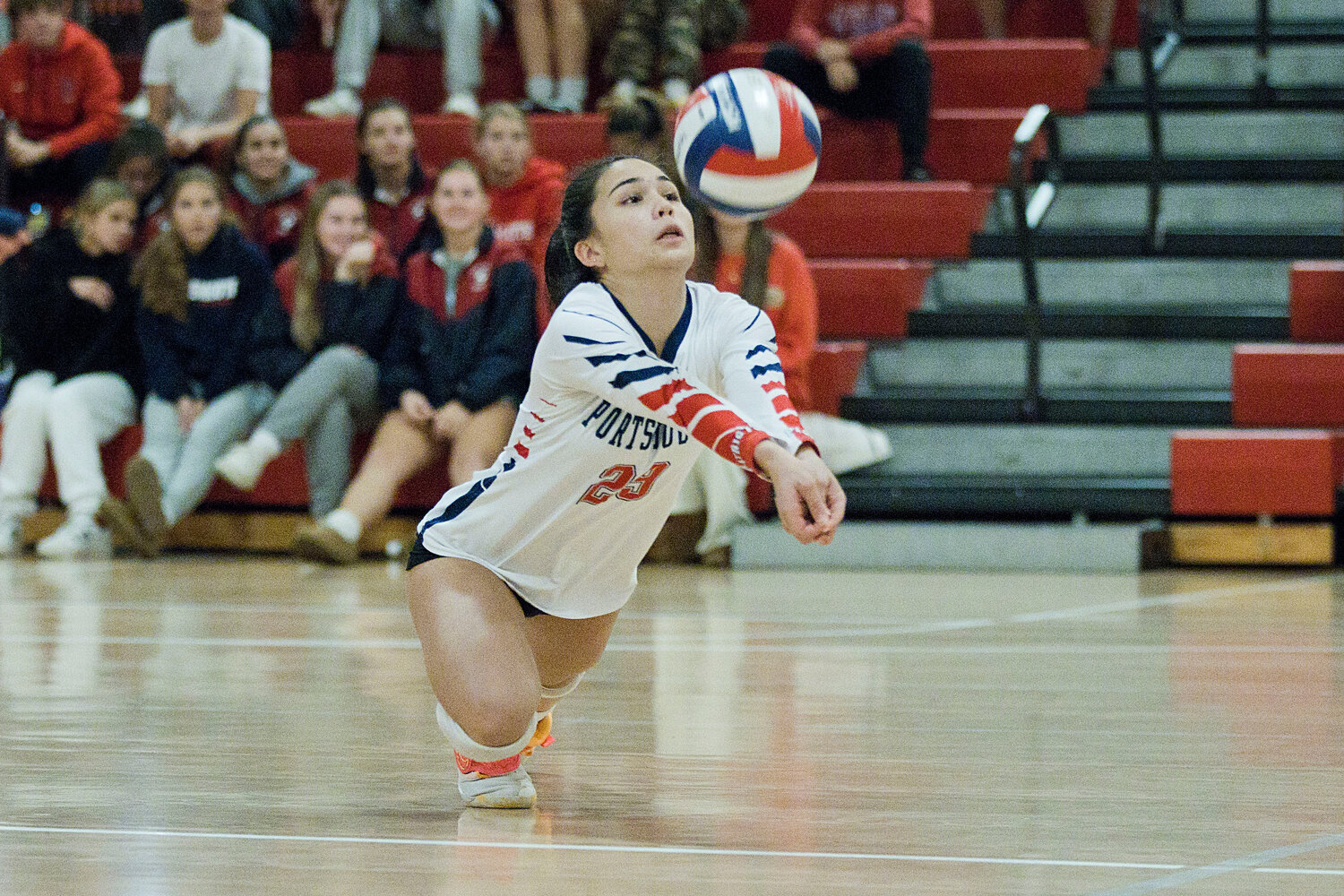 Mila Abedon dives under the ball to keep it in play against the Rams.