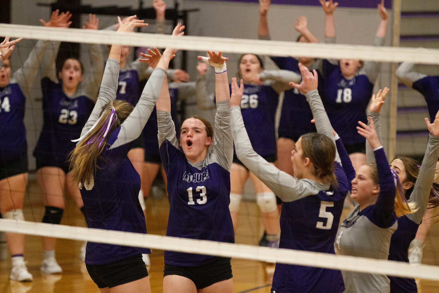 Mia Shaw and the Huskies celebrate after an ace.