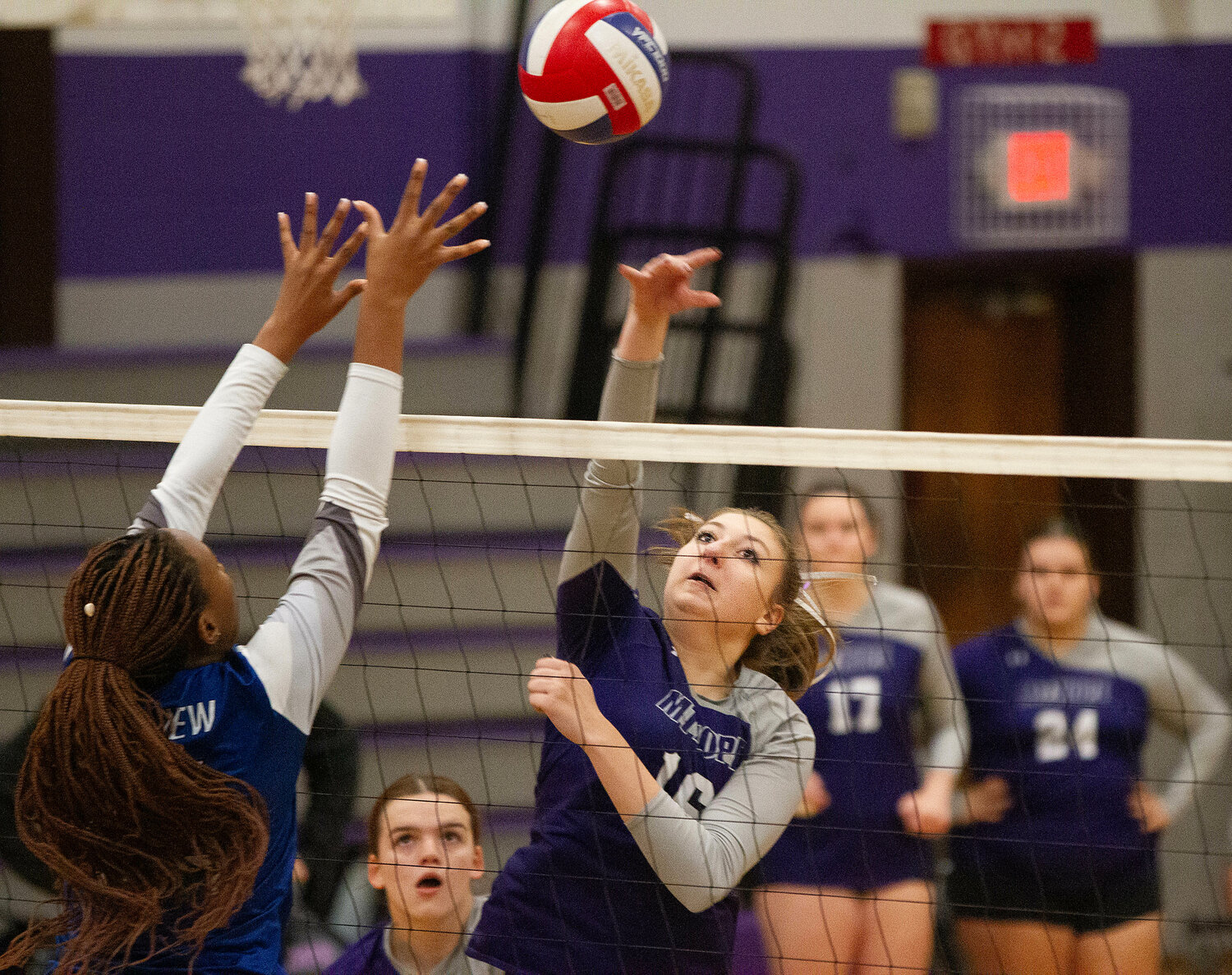 Abby Allen hits the ball over for a Huskies point.