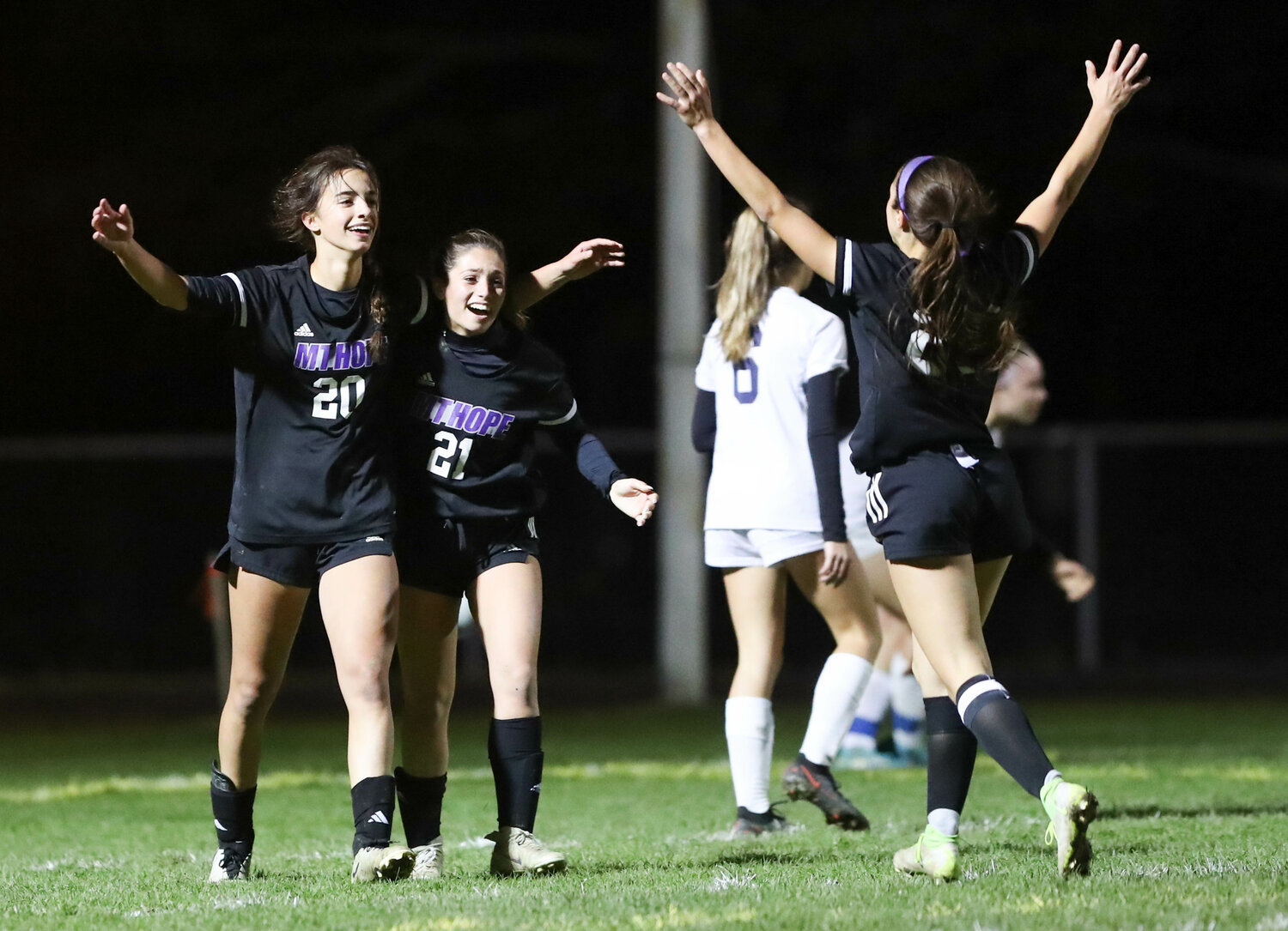 Thea Jackson (left) Lilliana Redman and a teammate celebrate after Jackson scored one of her three goals in the Huskies' 4-0 win over South Kingstown in the D-I quarterfinals on Friday.