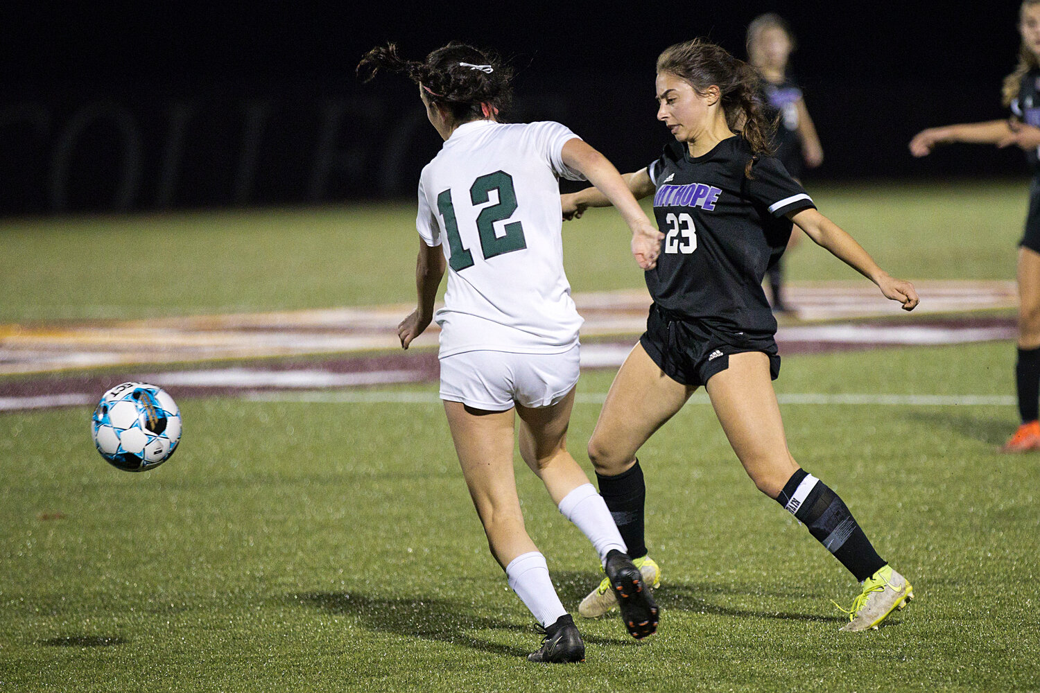 Hannah Rezendes boots the ball away from a Chariho opponent.