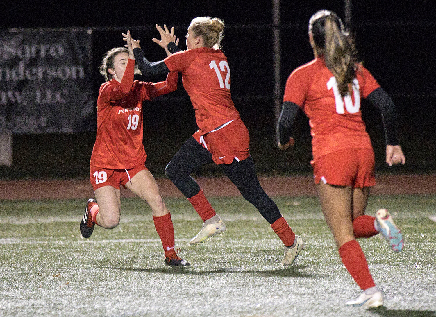 Claire Hook and Mollyana McGuire celebrate a goal in the first half of Wednesday's semifinal match against Lincoln.