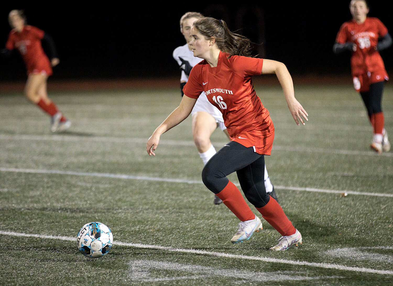 Evelyn Shuster dribbles upfield while battling Lincoln in the Division II semifinals Wednesday.