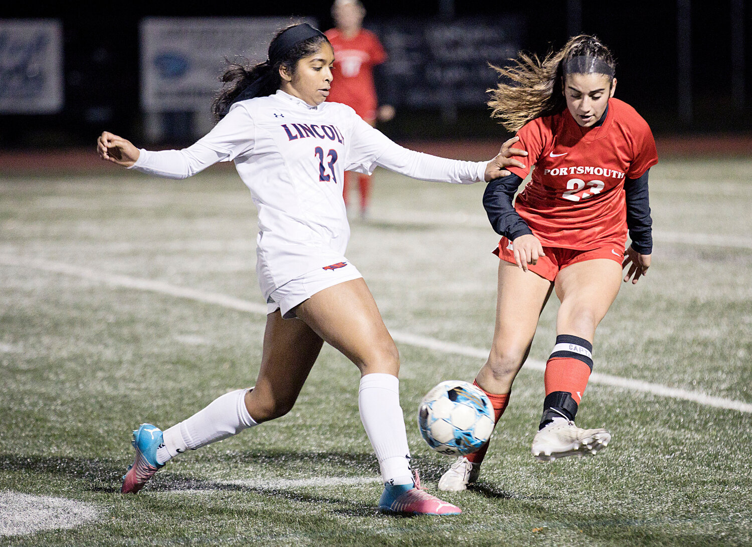 Sophia Karousos knocks the ball away from a Lincoln opponent.