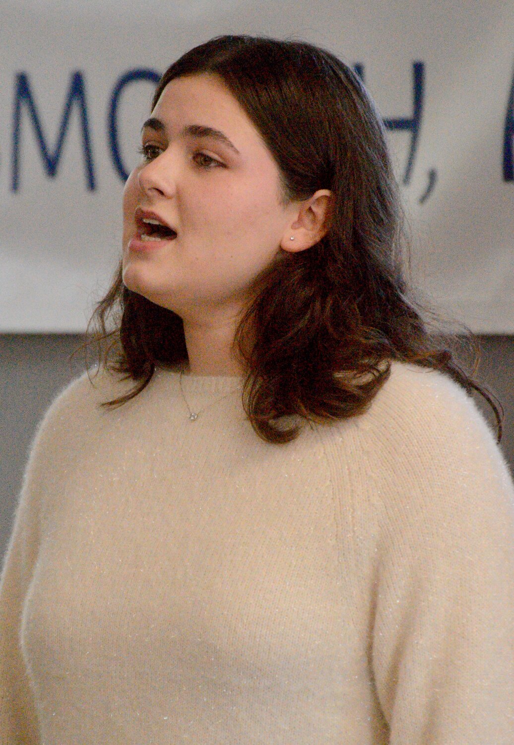 Addison Aleicho, a member of the Portsmouth High School Vocal Ensemble, sings The National Anthem at the start of the ceremony.