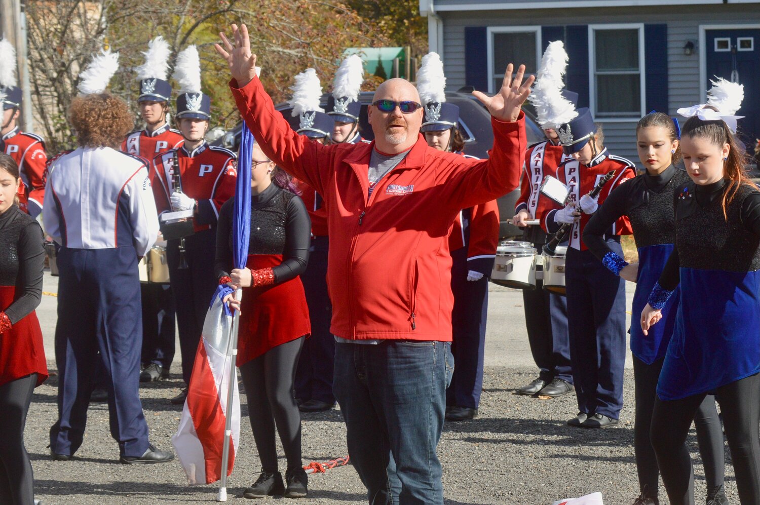 Portsmouth High School Band Director Ted Rausch thanks veterans for their service while introducing the marching band, which played a few numbers outside.