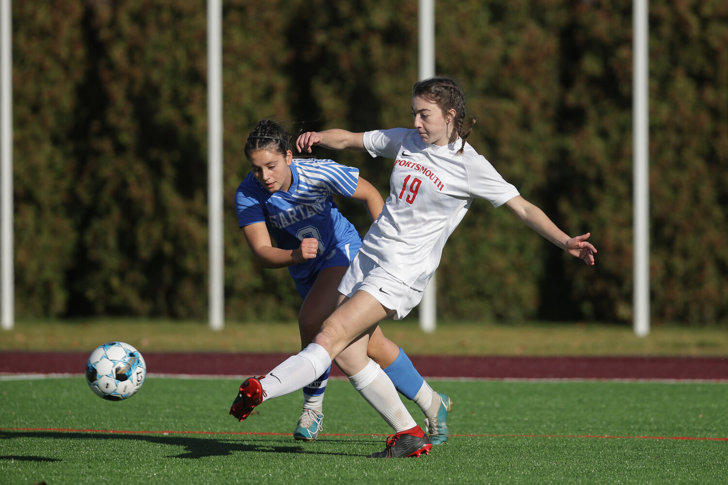The Patriots’ Clair Hook boots the ball by a defender. The senior would put the Patriots up 4-0, with a goal in the second half.