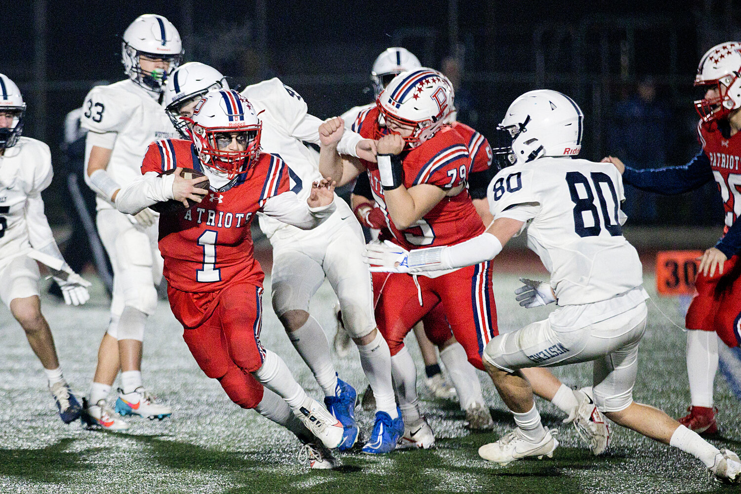 Aidan Maisen breaks free from the Westerly defense to gain yardage for the Patriots.