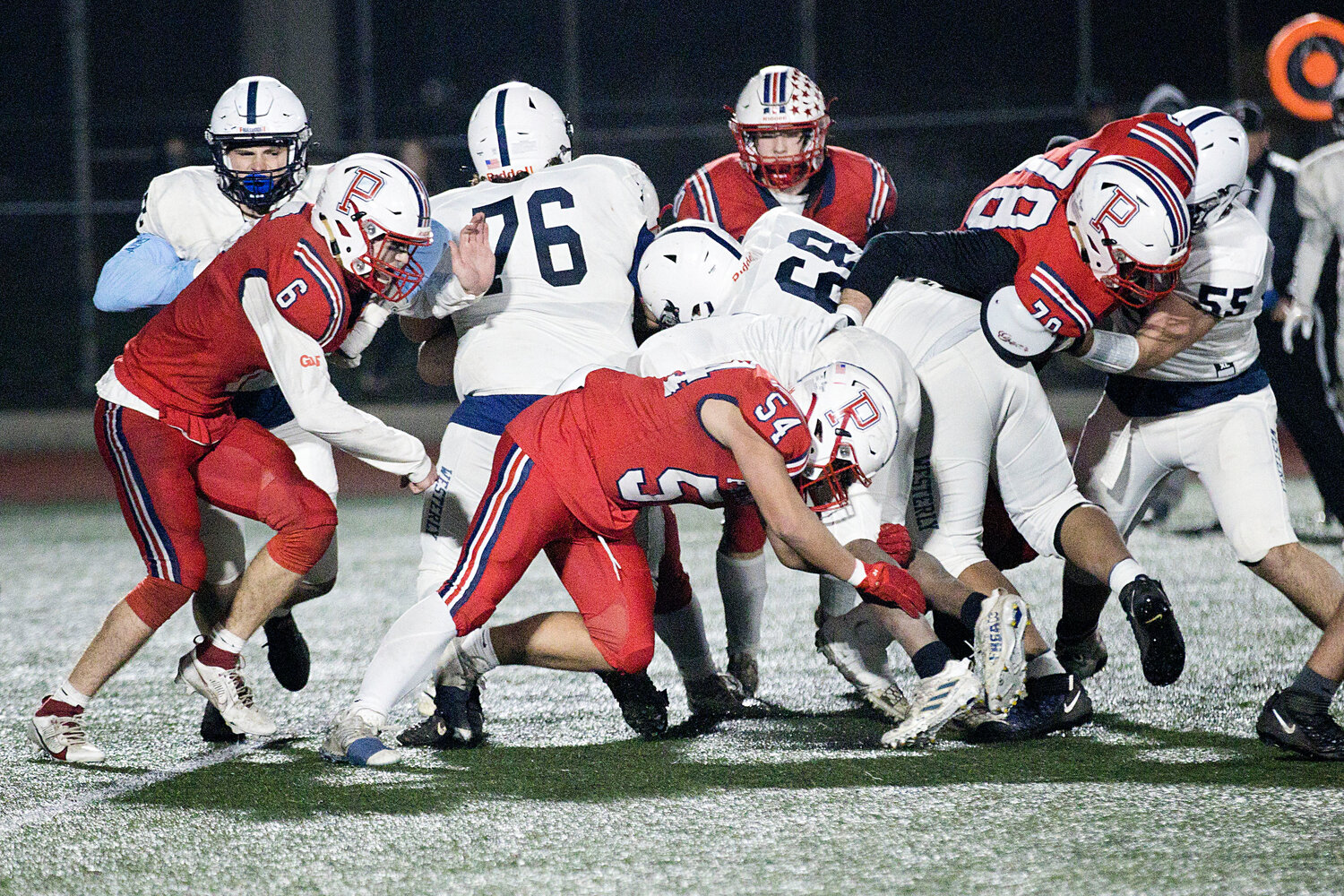 Tristan Conheeny (middle) tackles a Westerly running back at midfield.