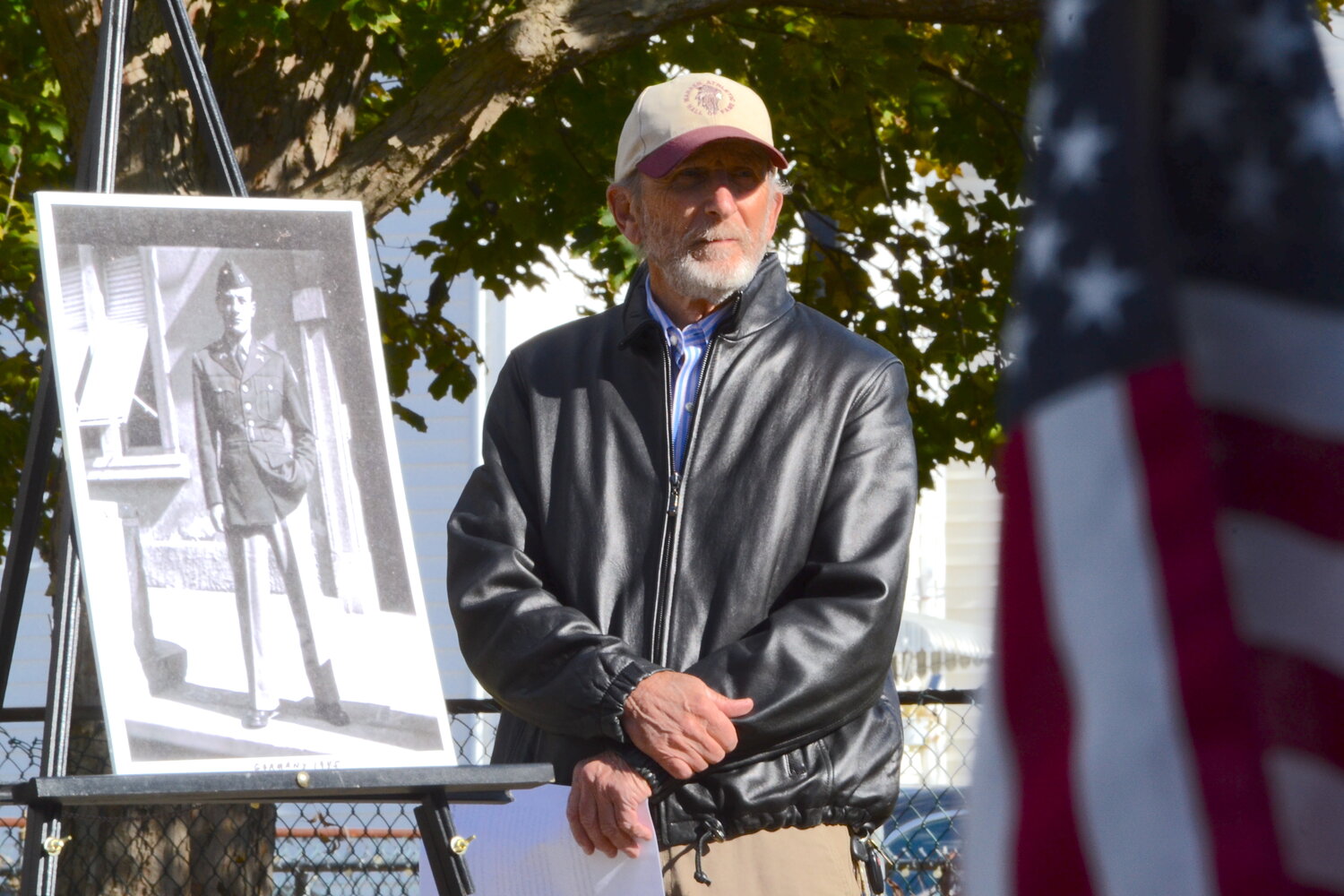 Lester ‘Butch’ Lombardi Jr. stands beside a portrait of his late father, Lester L. Lombardi, who would rise to the rank of captain while on active duty and became a company commander with the U.S. Army during World War II.
