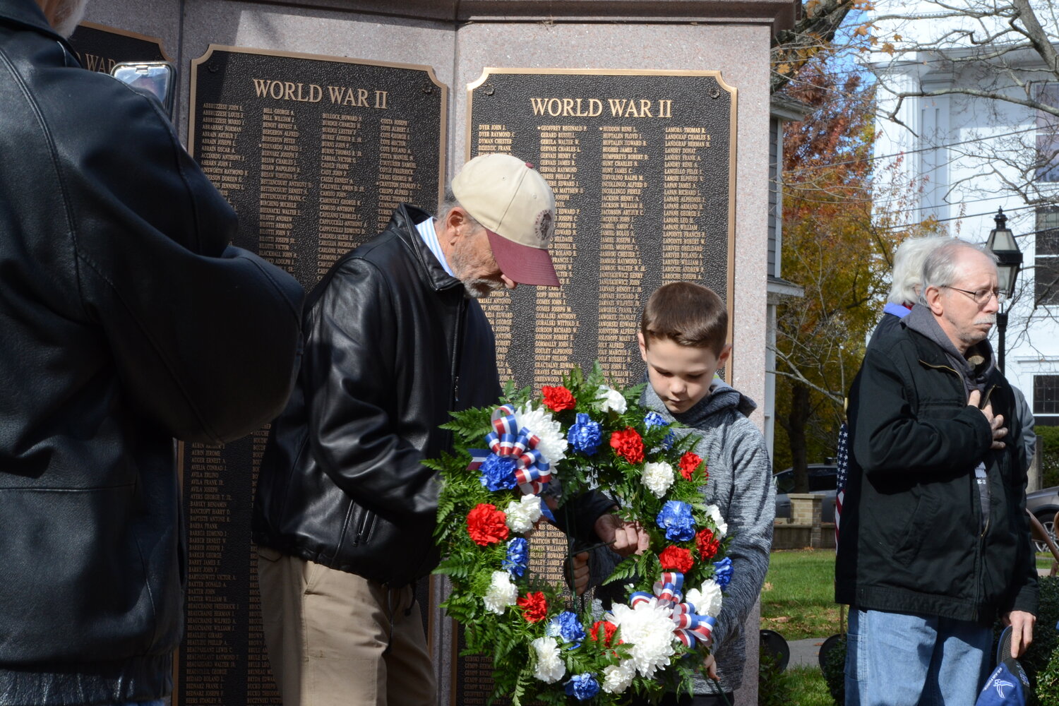 Butch Lombardi and his grandson, Andrew, place a wreath in honor of Lester Lombardi Sr. at the conclusion of the Veterans Day ceremony on Saturday, Nov. 11, 2023 at the Warren Honor Roll located at the Town Common.