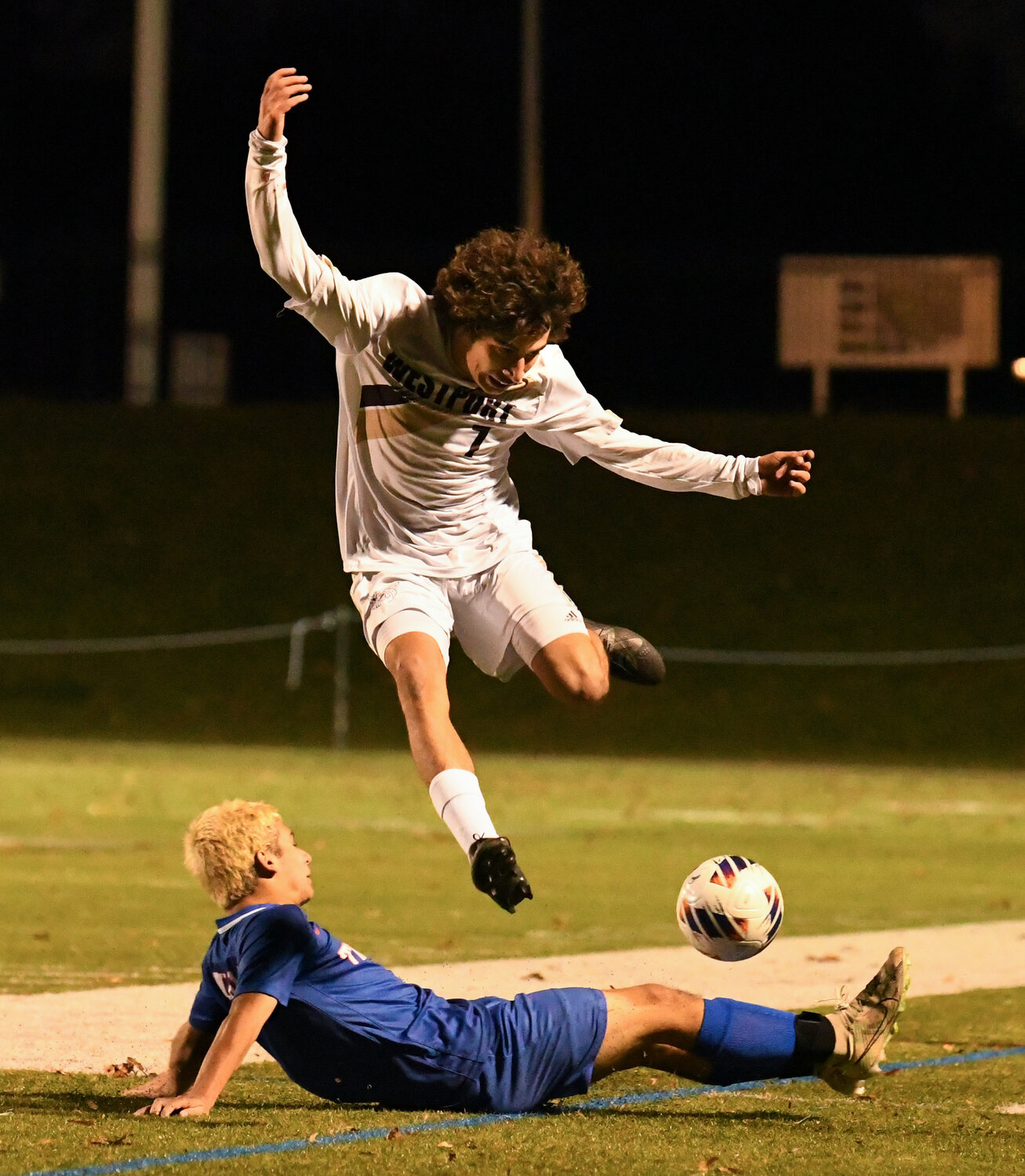 Zachary Lopes leaps over a Douglas player in Saturday’s state championship victory.