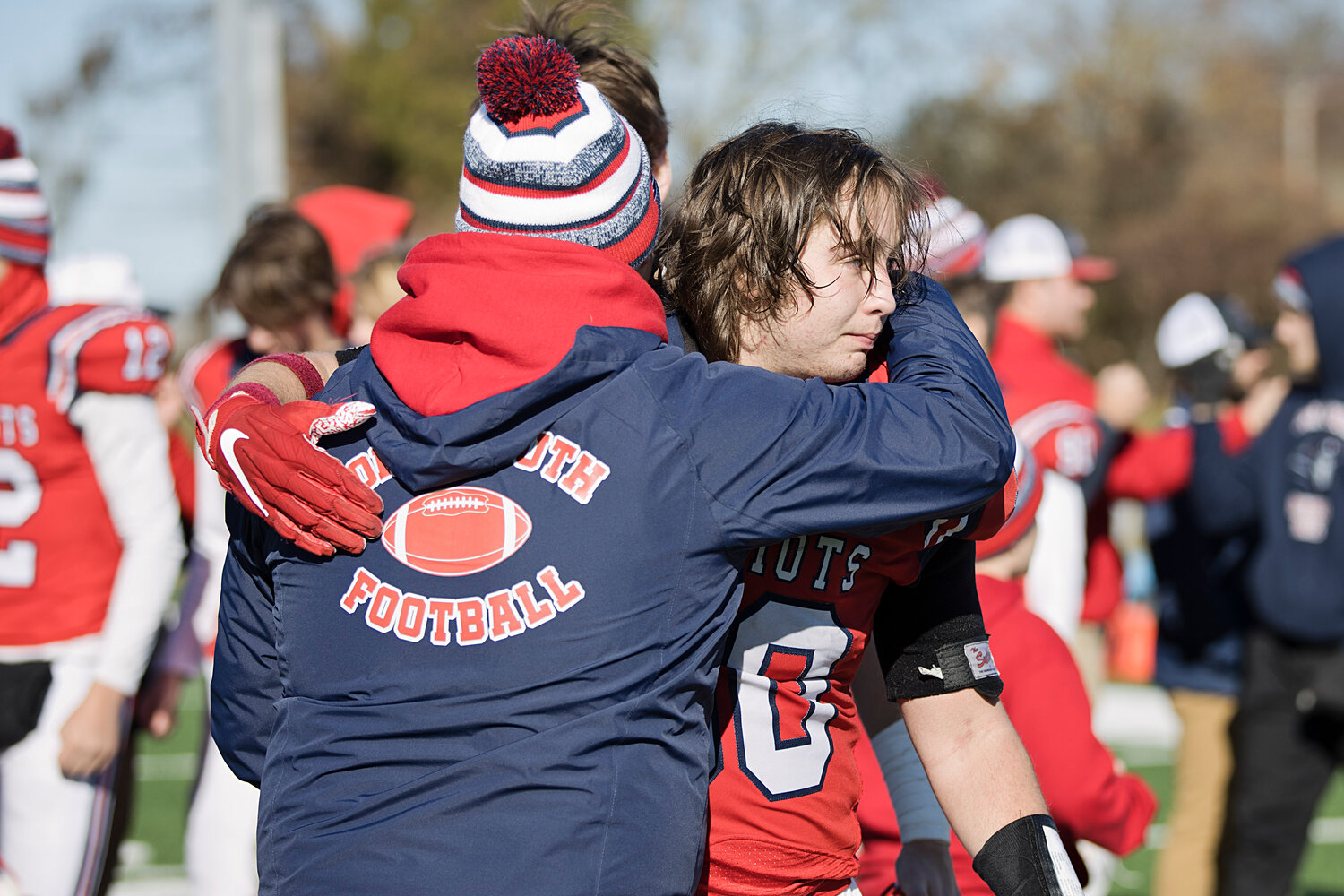 Senior Chase Fanning shares a hug with a coach after his final high school game.