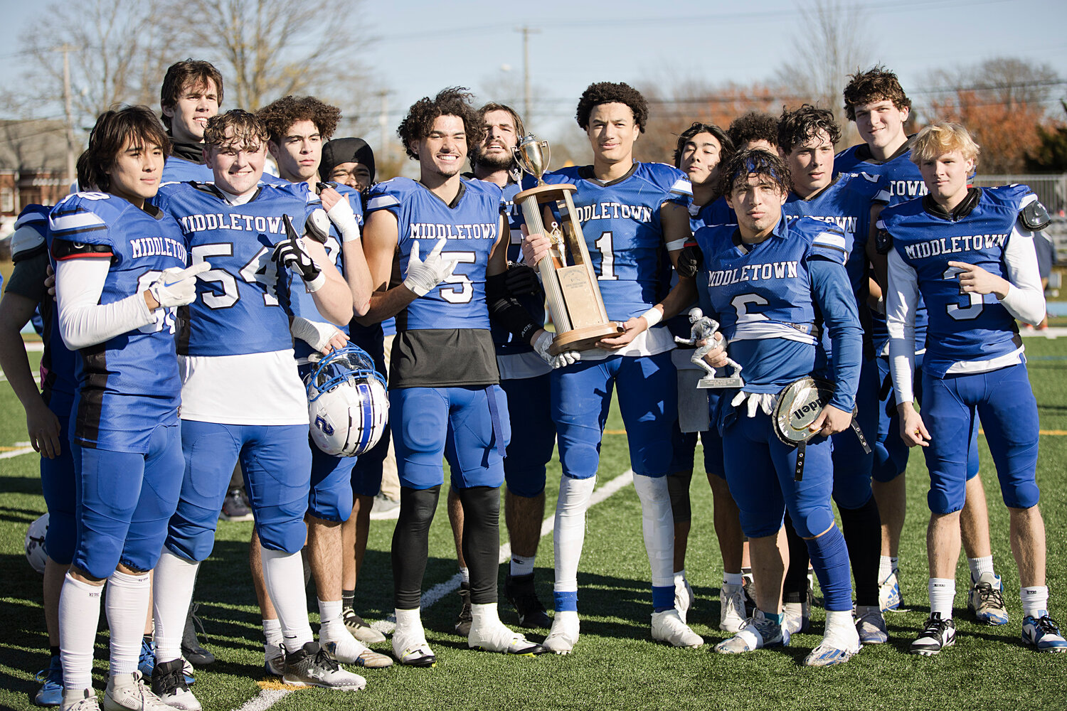 Middletown High School seniors pose with their trophy after beating Portsmouth 20-6 in the annual Thanksgiving game.