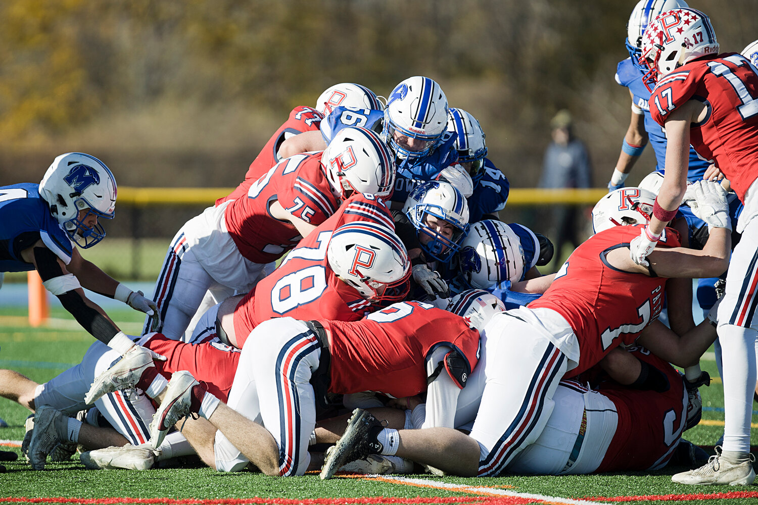 The Patriots’ offense forces its way over the goal line to score in the first half of Thursday's Thanksgiving Day match against Middletown.