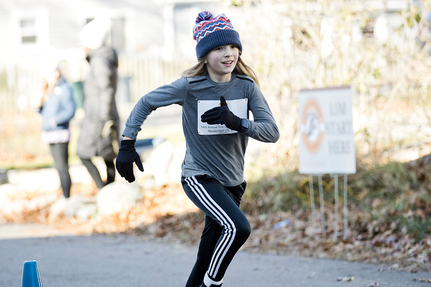 Dax Dimery runs toward the finish line of the 24th annual Trot Off Your Turkey 1.5 mile race.