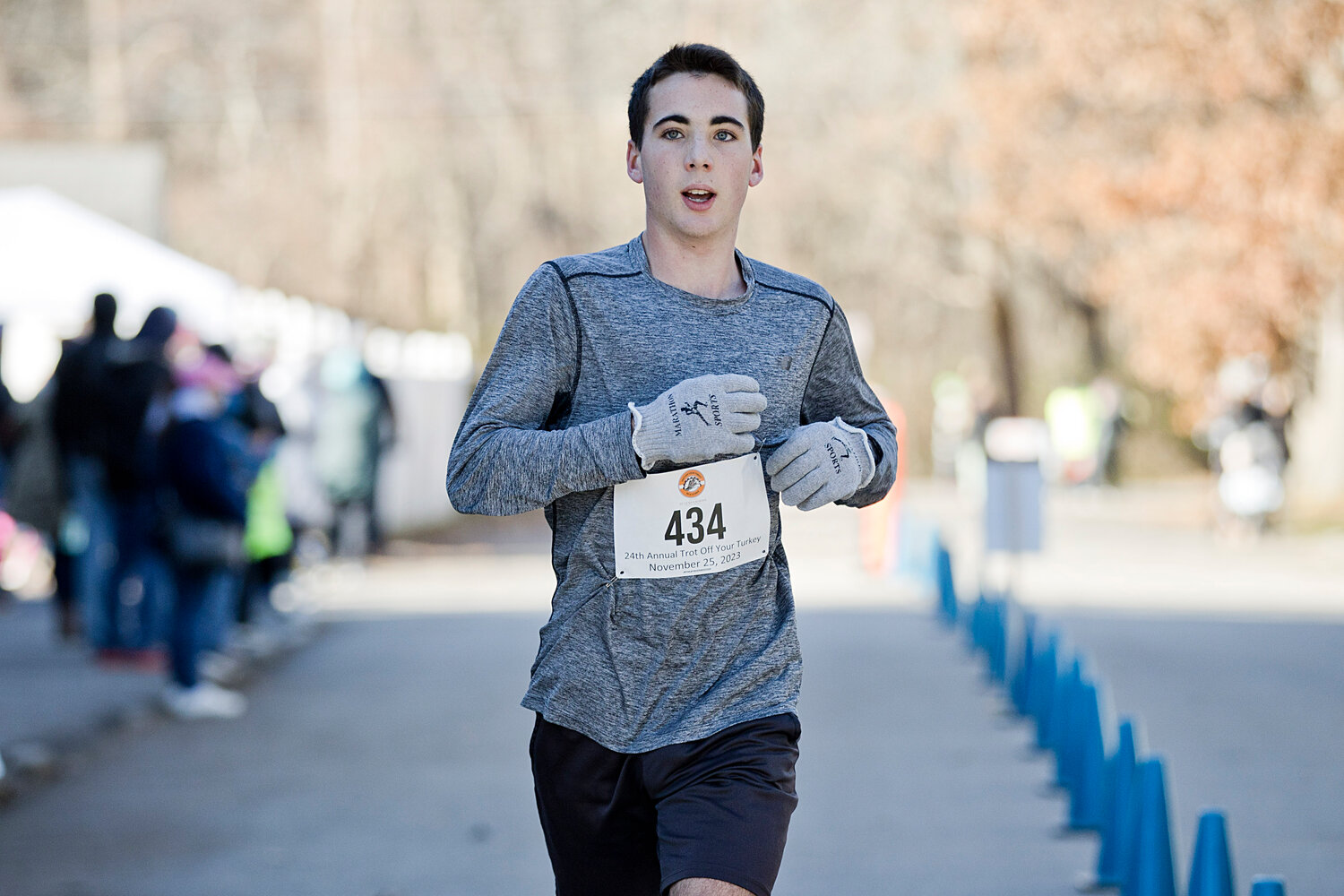 Barrington’s Connor Curran keeps his pace as he approaches the finish line of the Trot Off Your Turkey 5K race.