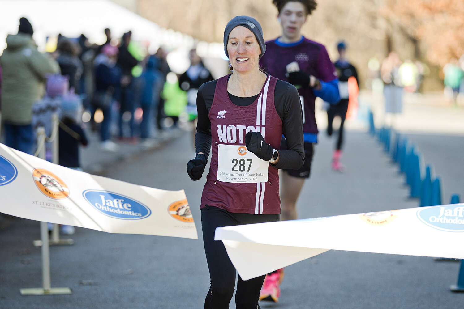 Top female finisher, Brett Ely, runs through the finish line of the Trot Off Your Turkey 5K, with a time of 18:54.
