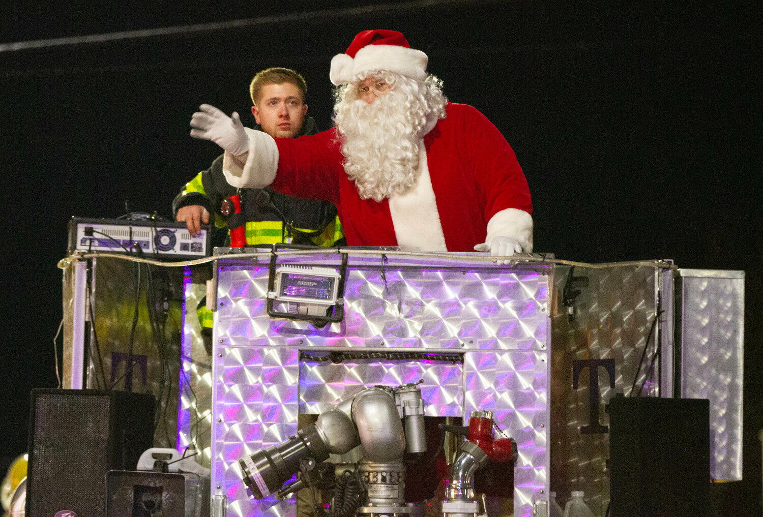 Santa makes his way down Main Street on Warren Fire Department's ladder one.