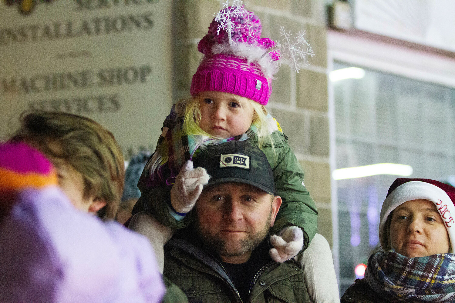 Anthony Defazio and daughter Bella, 4, look on as Santa boards ladder one.
