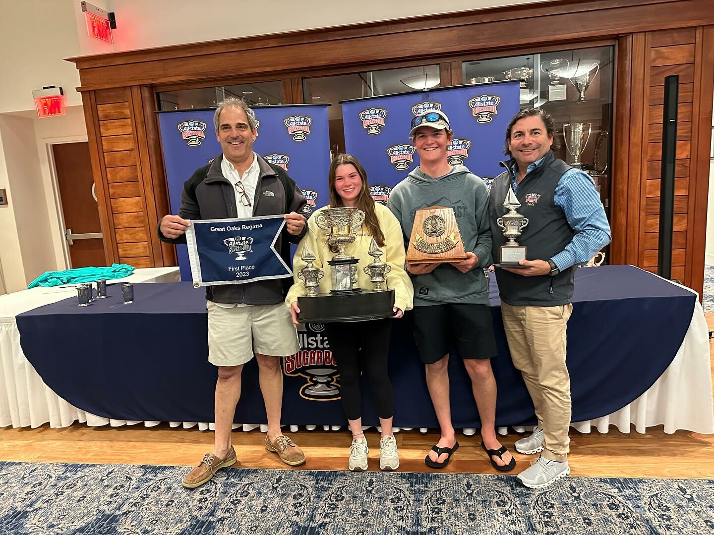 Barrington High School sailing team members Avery Guck (middle left) and Christopher Chwalk (middle right) display the trophies after Barrington won the recent Great Oaks Regatta in Louisiana.