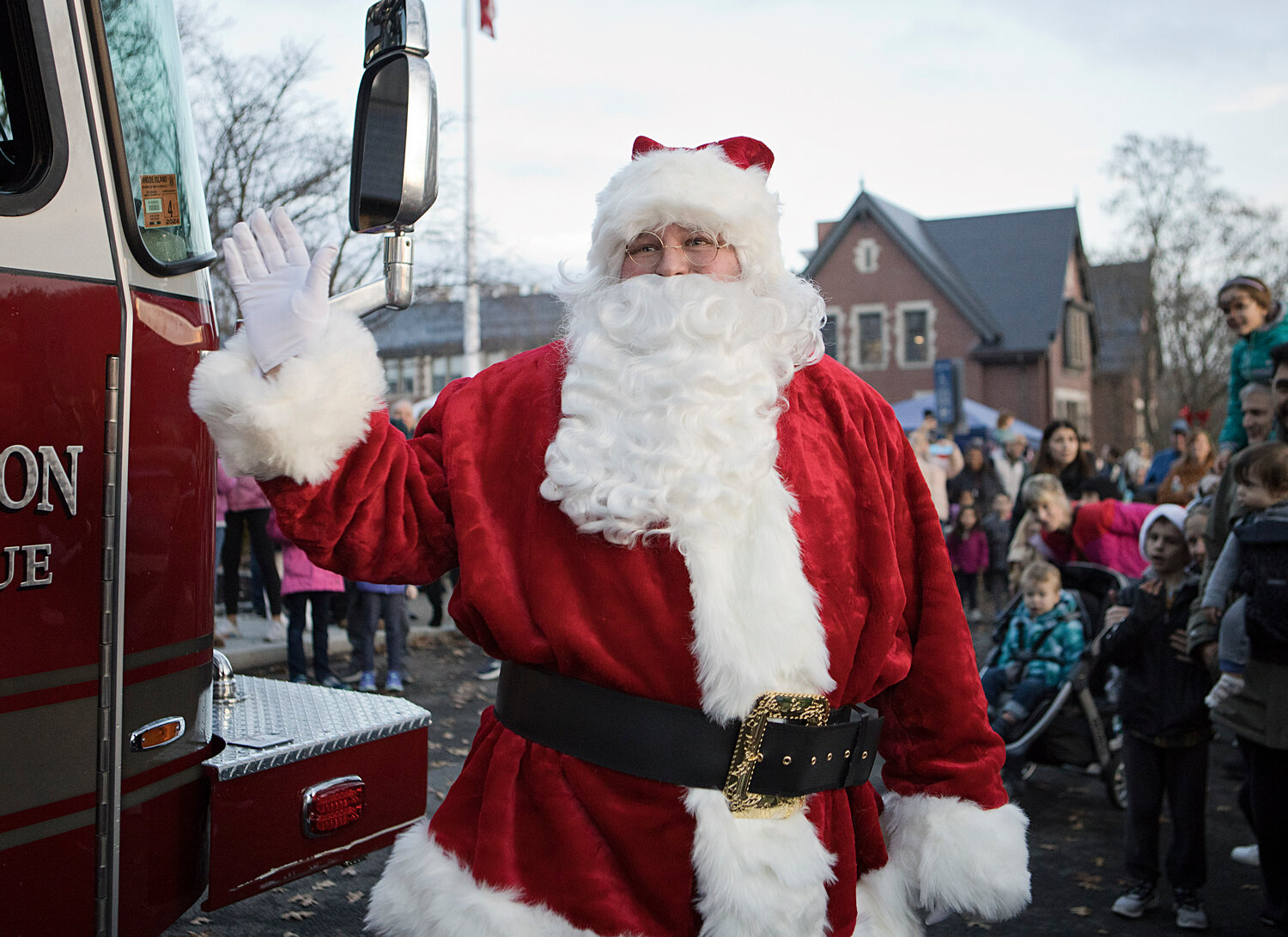 Santa waves to the crowd as he climbs out of a fire truck at the tree-lighting event in town on Saturday, Dec. 2.