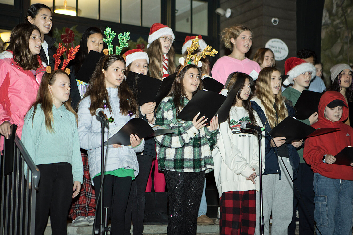 Barrington Middle School students sing for guests at Barrington's Tree Lighting, Saturday.